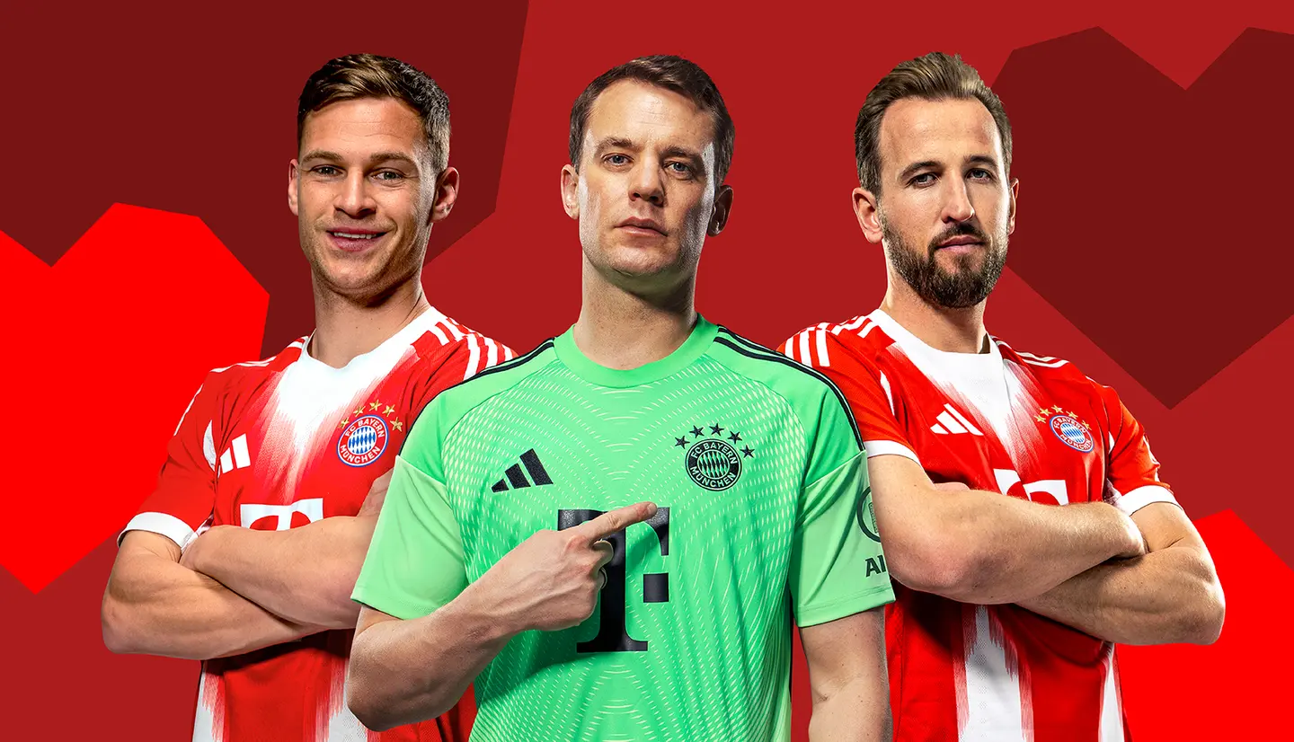 Three soccer players from Bayern Munich are standing together. The first player on the left is smiling, wearing a red jersey. The middle player, a goalkeeper in a green uniform, points to his chest. The third player on the right has a serious expression and a beard, also in a red jersey.