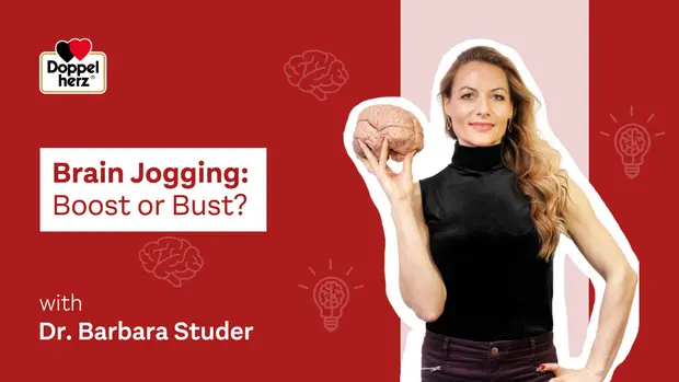 A woman holding a model of a brain stands in front of a red background. The text reads, "Brain Jogging: Boost or Bust? with Dr. Barbara Studer." Light bulb icons are present, suggesting ideas or insights related to brain health.