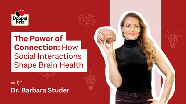 A woman holds a model of a brain while standing against a red background. The text reads, "The Power of Connection: How Social Interactions Shape Brain Health" with the name "Dr. Barbara Studer." The image emphasizes the importance of social connections for brain health.